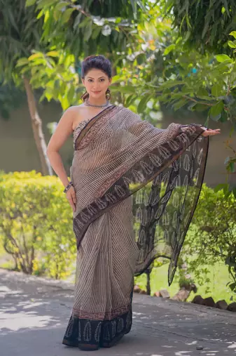 Cream kota doria saree with black stripes, black border and pallu