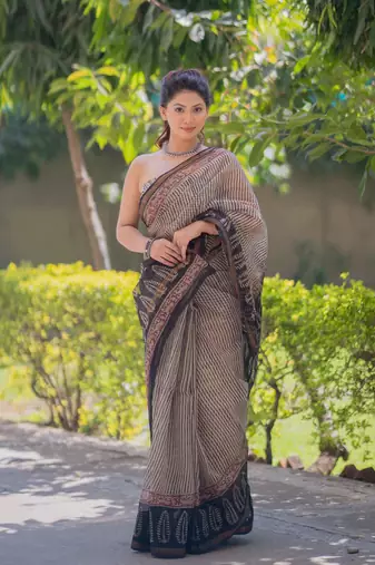 Cream kota doria saree with black stripes, black border and pallu