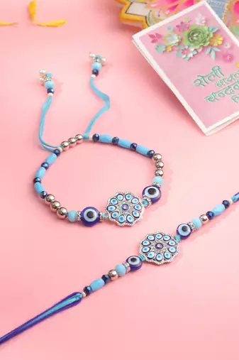 set of 2 blue evil eye floral design bhaiya bhabhi rakhi with roli chawal chandan & mishri