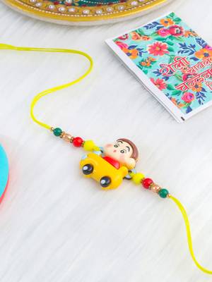kids yellow cartoon artificial beads rakhi with roli chawal chandan & mishri 1