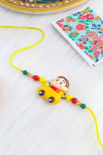 kids yellow cartoon artificial beads rakhi with roli chawal chandan & mishri