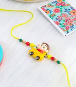 kids yellow cartoon artificial beads rakhi with roli chawal chandan & mishri