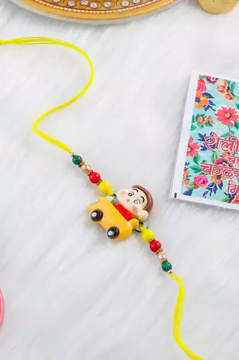 kids yellow cartoon artificial beads rakhi with roli chawal chandan & mishri