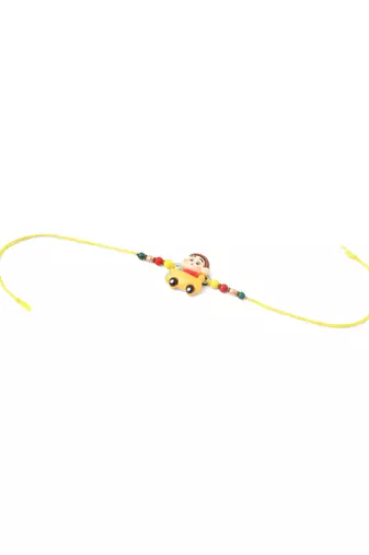 kids yellow cartoon artificial beads rakhi with roli chawal chandan & mishri