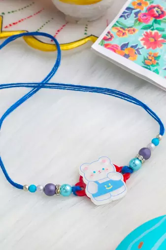 kids teddy blue artificial beads thread rakhi with roli chawal chandan & mishri
