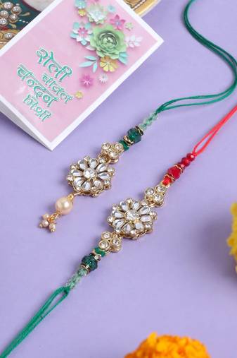 set of 2 gold toned kundan studded floral design bhaiya bhabhi rakhi with roli chawal chandan & mishri