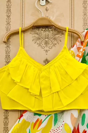 Vibrant floral lehenga with yellow ruffle top