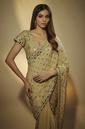 Gold pre drapped chinnon chiffon sequins saree with mirror and sequins hand embroidery.