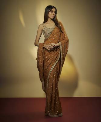 Copper chinnon chiffon sequins and mirror embroidered saree with mirror embroidered bustier . 1