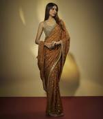 Copper chinnon chiffon sequins and mirror embroidered saree with mirror embroidered bustier .