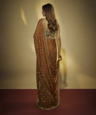 Copper chinnon chiffon sequins and mirror embroidered saree with mirror embroidered bustier . 2