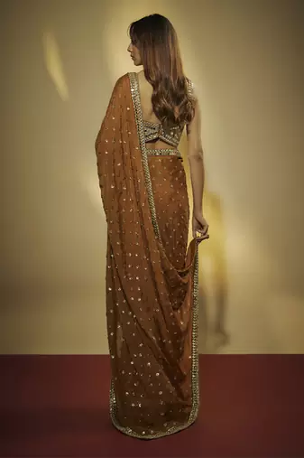 Copper chinnon chiffon sequins and mirror embroidered saree with mirror embroidered bustier .