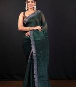 Dark green jimmy choo saree with intricate silver embellishments and beautiful curve border