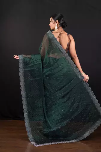 Dark green jimmy choo saree with intricate silver embellishments and beautiful curve border