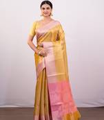 Gold tissue art silk saree with detailed pink zari border