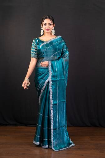 Teal blue jimmy choo saree with intricate silver embellishments and blouse