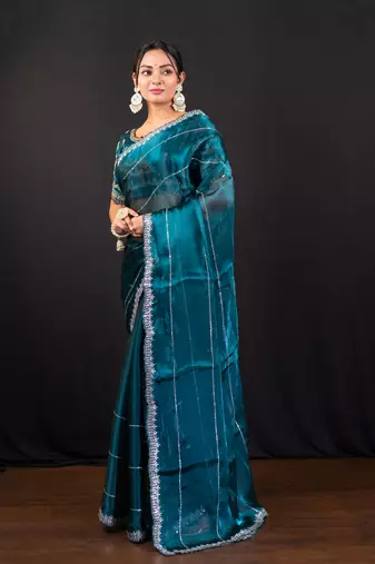 Teal blue jimmy choo saree with intricate silver embellishments and blouse