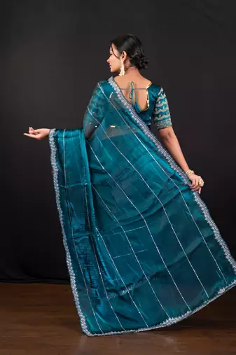Teal blue jimmy choo saree with intricate silver embellishments and blouse