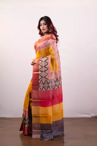 Yellow handpainted  tussar silk saree with red alpana design and multi pallu