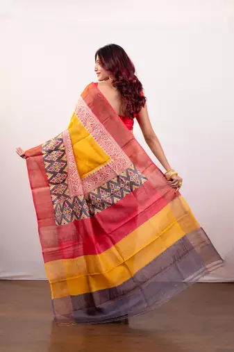 Yellow handpainted  tussar silk saree with red alpana design and multi pallu