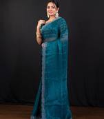 Teal blue jimmy choo saree with intricate silver embellishments and beautiful curve border