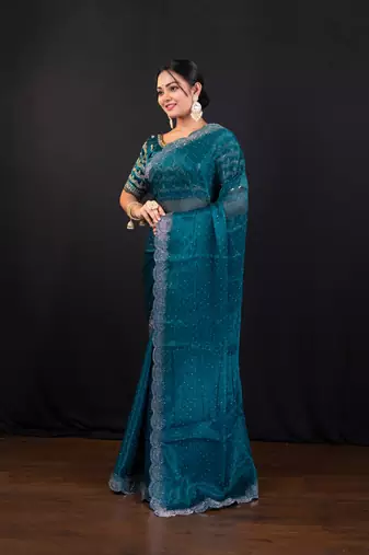 Teal blue jimmy choo saree with intricate silver embellishments and beautiful curve border