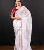 White jimmy choo saree adorned with intricate silver embellishments and a beautifully detailed border with ready blouse