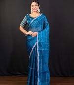 Blue jimmy choo saree adorned with intricate silver embellishments and a beautifully detailed border with ready blouse