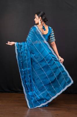 Blue jimmy choo saree adorned with intricate silver embellishments and a beautifully detailed border with ready blouse 3