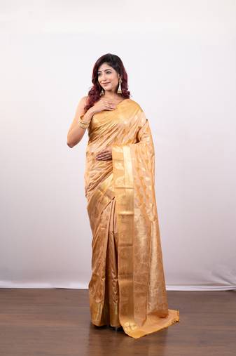 Kanjivaram art silk saree in peach  cover floral motifs and border