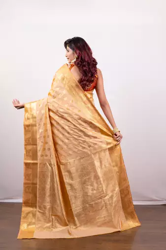 Kanjivaram art silk blend saree in peach cover floral motifs and border