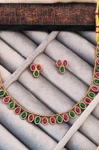 Traditional gold-plated necklace set with ruby red and emerald green stones, matching earrings
