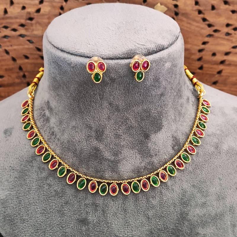 Traditional gold-plated necklace set with ruby red and emerald green stones, matching earrings