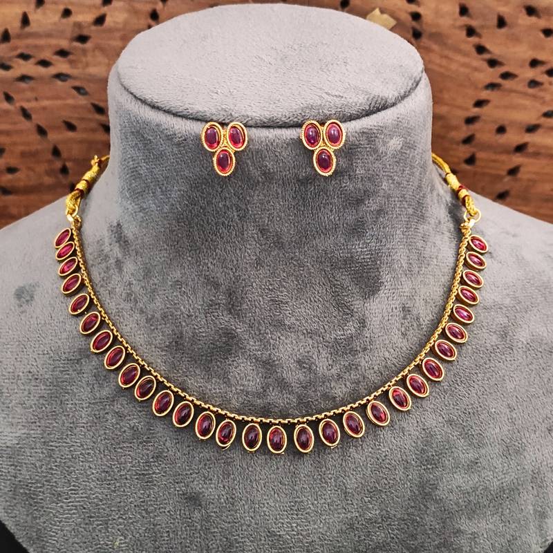 Traditional gold-plated necklace set with ruby red stones, oval design, matching earrings