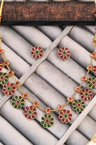 Traditional gold-plated floral necklace set with ruby and emerald stones, flower design earrings