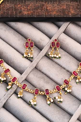 Traditional gold-plated necklace set with ruby red stones, pearl drops, green beads and matching earrings
