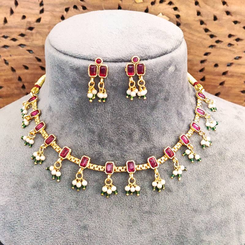 Traditional gold-plated necklace set with ruby red stones, pearl drops, green beads and matching earrings