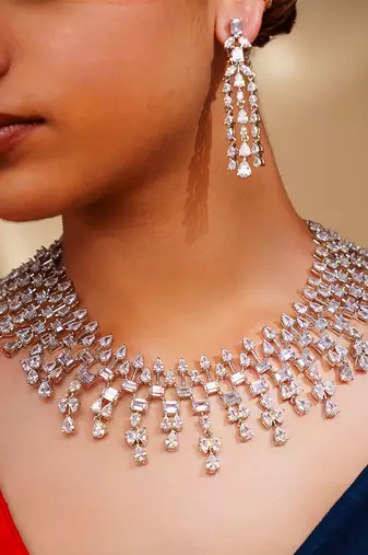 Delicate yet elegant diamond necklace in white finish with matching earrings