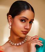Classy kundan necklace with elegant pair of earrings.