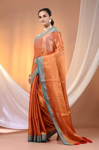 Orange shimmer tissue saree with nakshi borders