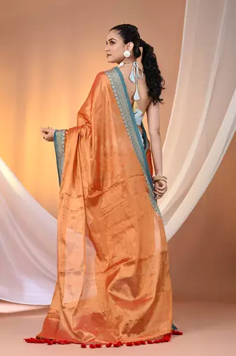 Orange shimmer tissue saree with nakshi borders