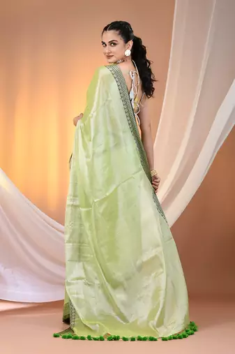 Light green shimmer tissue saree with nakshi borders