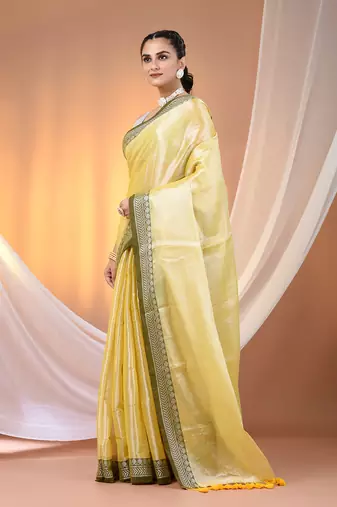 Yellow shimmer tissue saree with nakshi borders
