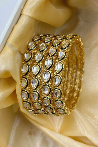 Gold designer bangle set with green touch for women