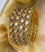 Gold designer bangle set with green touch for women