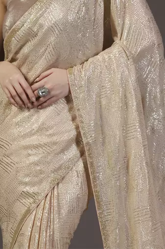 Nude and gold sequins hand embroidered georgette saree with unstitched blouse sets of 2