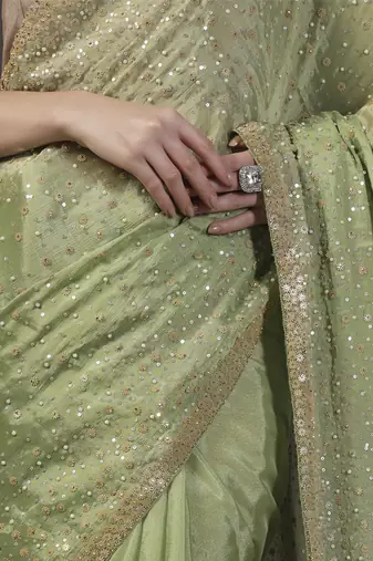 Green embellised tine dull sequins embroidered georgette saree with unstitched blouse sets of 2
