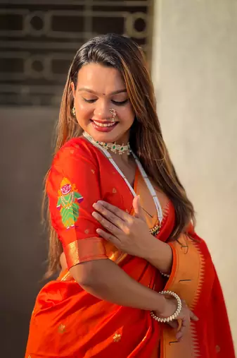 Bright orange zari woven vitthala god paithani silk blend saree