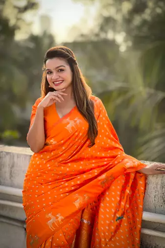 Orange soft silk blend dual zari woven saree with deer border