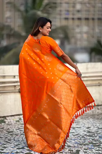 Orange soft silk blend dual zari woven saree with peacock border